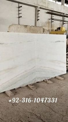 a large white marble slab in a warehouse