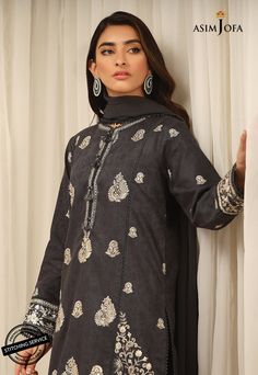 FABRIC: SELF-JACQUARDCOLOR: CHARCOAL GREY A traditionally rich composition is aptly portrayed on this appealing cotton ensemble rendered in a captivating charcoal grey shade. This beautiful shirt is paired with a cambric trouser and a chiffon dupatta. A heritage rich outfit that is a fashion statement to embrace at festive events.DESIGN DETAILS:1 Embroidered Center panel for Front on Self-Jacquard1 Embroidered Neckline on Self-Jacquard2 Embroidered Side Panels for Front on Self-Jacquard (Right a Elegant Cotton Tops With Printed Motifs, Festive Gray Sets With Chikankari Embroidery, Gray Chikankari Embroidery Traditional Sets, Traditional Gray Chikankari Embroidery Sets, Gray Traditional Sets With Chikankari Embroidery, Traditional Gray Embroidered Sets, Gray Eid Sets With Dupatta, Black Cotton Sets With Printed Motifs, Fitted Cotton Gray Set