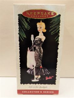 a box with an image of a woman in a black dress holding a white bag