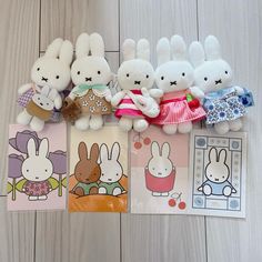 several stuffed animals sitting on top of each other next to some cards and envelopes