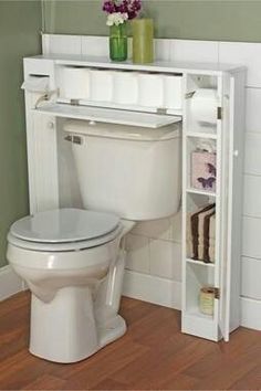 a white toilet sitting in a bathroom next to a book shelf