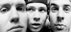 three young men are posing for the camera with their mouths open and tongue hanging out