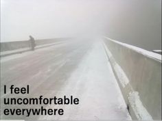 a person standing on the side of a snow covered road next to a bridge with text that reads, i feel uncomfortableable everywhere