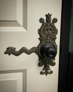 an ornate door handle on a white door