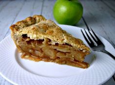 a slice of apple pie on a white plate