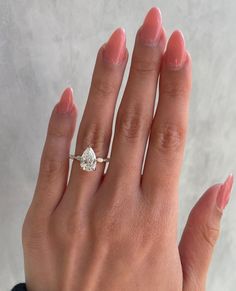 a woman's hand with a diamond ring on it