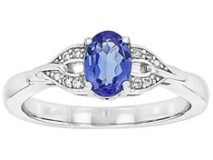 0.65ct Oval Tanzanite With 0.05ctw Round White Zircon Rhodium Over Sterling Silver Ring. Measures Approximately 0.20"L x 0.27"W. Not sizeable. Accent stones primarily zircon. Oval Diamond Birthstone Ring With Diamond Accents, Oval White Gold Birthstone Ring With Diamond Accents, Blue Tanzanite, Sterling Silver Ring, Silver Ring, Sterling Silver Rings, Silver Rings, Sterling Silver, Ring