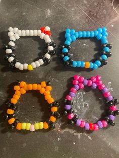 four different colored bracelets sitting on top of a table