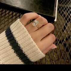 a woman's hand with a ring on it