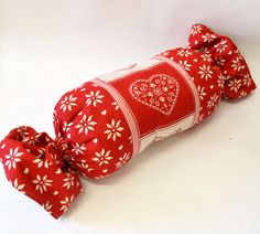 a red and white pillow with hearts on it