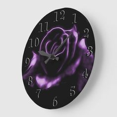 a black and purple clock with a rose on it