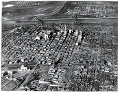 an old black and white photo of a city with lots of tall buildings on it