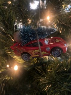 a red car ornament hanging from a christmas tree