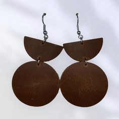 Elevate your style with our exquisite handmade leather earrings. Crafted from high-quality, genuine leather, these earrings boast a perfect blend of elegance and durability. Each pair is meticulously designed to ensure unique, artisanal charm. Featuring either hypoallergenic stainless steel or gold plated stainless steel earring wires, they offer not only a stylish look but also comfort and safety for sensitive ears. Lightweight and comfortable for all-day wear, these earrings make a bold yet so Minimalist Brown Hoop Earrings For Everyday, Modern Brown Round Jewelry, Handmade Brown Faux Leather Earrings, Everyday Brown Metal Earrings, Handmade Leather Earrings For Everyday, Handmade Leather Hoop Earrings, Handmade Leather Everyday Earrings, Nickel Free Leather Drop Earrings, Handmade Minimalist Leather Earrings