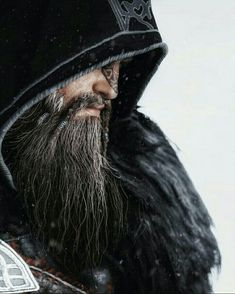 an old man with a beard wearing a black coat