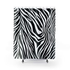 a black and white shower curtain with zebra print on it's side, in front of a white background