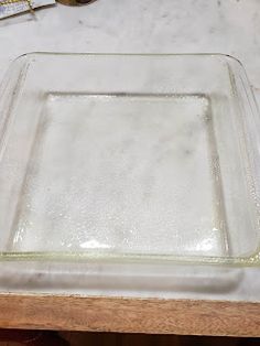 a square glass dish sitting on top of a table