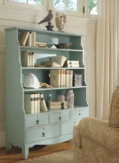 a blue bookcase with many books on it