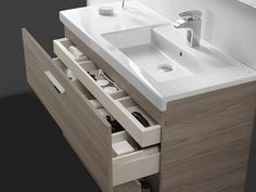 a bathroom vanity with two sinks and drawers underneath the sink is made of oak wood