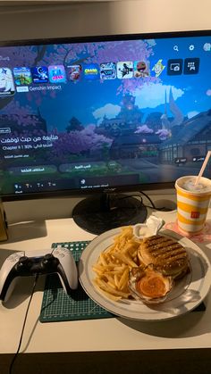 a plate with french fries and waffles next to a video game on the tv