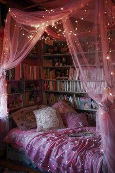 a bedroom with pink bedding and fairy lights