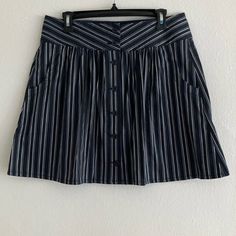 This Pinstripe Mini Comes In X-Small, Small, Medium & Large Gathered Front Button Down Front Closure Functional Pockets Black And White Comes With A Spare Button Lay Flat Measurements X-Small: -Waist 13” -Length 17 1/2” Small: -Waist 14” -Length 17 1/2” Medium: -Waist 15” -Length 18” Large: -Waist 16” -Length 18” Striped Cotton Bottoms With Buttons, Striped Lined Skirt For Day Out, Striped Mini Skirt For Day Out, Striped Relaxed Skirt For Day Out, Striped Bottoms With Buttons For Summer, Striped Summer Bottoms With Buttons, Striped Cotton Relaxed Skirt, Striped Lined Skort For Summer, Summer Striped Lined Skort