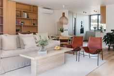 a living room filled with furniture and lots of windows