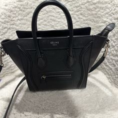 In Perfect Condition No Tears Or Scratches Looks Brand New High-end Black Leather Bags, Luxury Black Bag With Zipper Closure, High-end Black Textured Leather Shoulder Bag, Designer Black Bags With Leather Lining, Designer Black Shoulder Bag With Leather Lining, Celine Nano Luggage, Celine Bags, Luggage Bag, Celine Bag