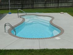 an empty swimming pool in a backyard