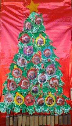 a christmas tree made out of photo frames on top of a bulletin board with the names of people around it