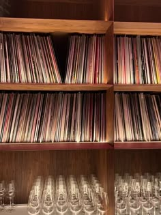 the shelves are filled with various records and wine glasses