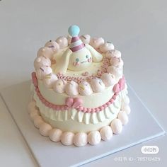 a cake with white frosting and pink decorations