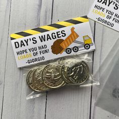 three different types of coins in plastic wrappers on a table with tags and stickers