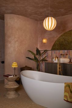 a bathroom with a large bathtub next to a sink