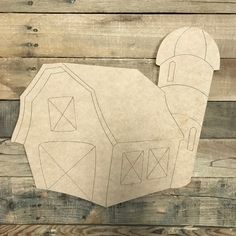 a paper cut out of a house on top of wooden planks with the shape of a head