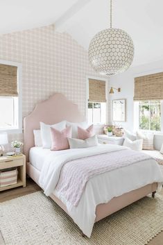 a bedroom with pink and white decor