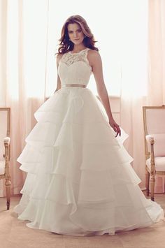 a woman in a white wedding dress posing for the camera