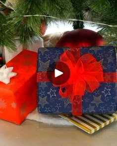 presents under the christmas tree are wrapped in red and blue paper