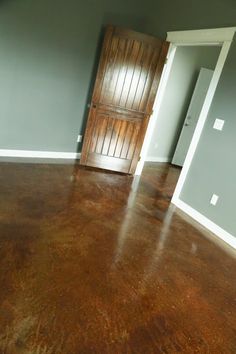 an empty room with a wooden door in it