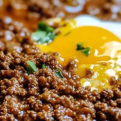 a close up of food on a plate with meat and eggs in the middle,