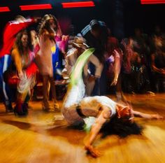 a group of people dancing on a wooden floor