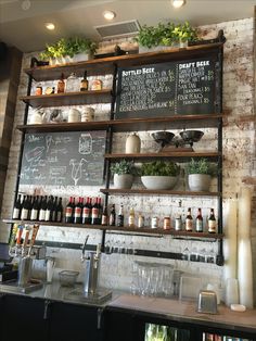 a bar with lots of bottles and glasses on the shelves next to eachother