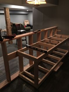 a room with some chairs and a table made out of wooden planks in it