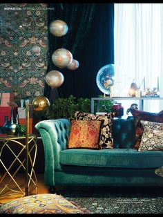 a living room filled with furniture and lots of pillows on top of it's couches