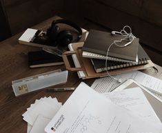 many papers and headphones are on the table