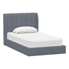 a bed with a blue headboard and white sheets on it's bottom half