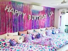 a bedroom decorated in pink, purple and blue