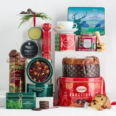 a variety of food items are displayed on a shelf in front of a white wall