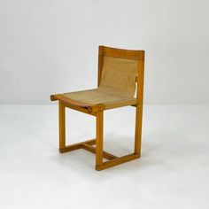 a wooden chair sitting on top of a white floor