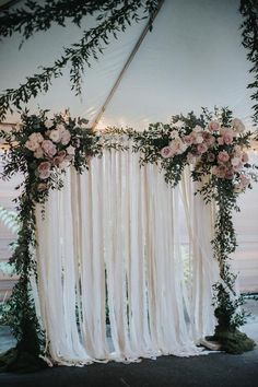 the wedding arch is decorated with flowers and greenery